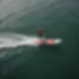 Aerial view of wake foil surfer gliding above the water