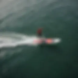 Aerial view of wake foil surfer gliding above the water