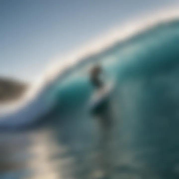 Surfer riding a wave with clear blue skies