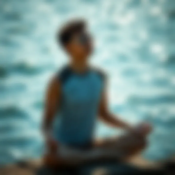 A person meditating by the water, emphasizing mindfulness and breathing awareness.