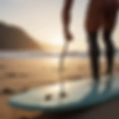 Surfer examining leash length on beach