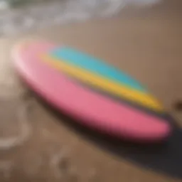 A colorful foam surfboard on the beach