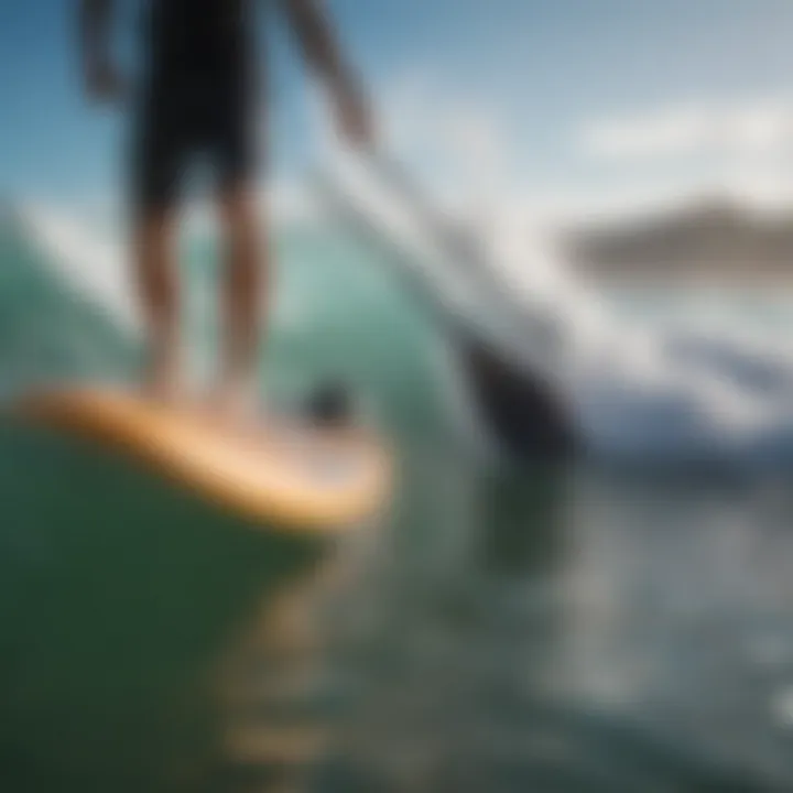 Close-up of paddle boarder maneuvering through waves