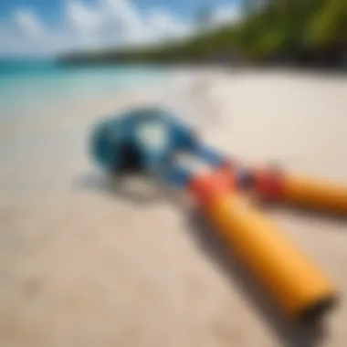 Colorful snorkeling gear laid out on a sandy beach