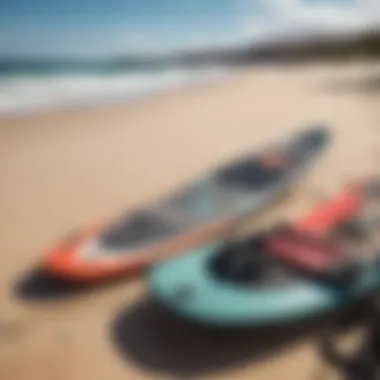 Close-up of high-quality kiteboarding gear laid out on a sandy beach with crystal clear waters in the background