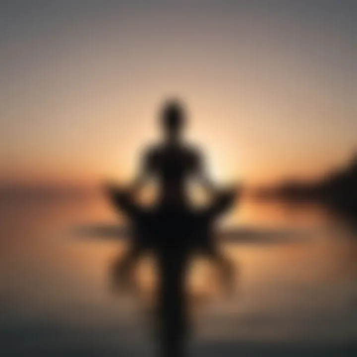 Silhouette of person meditating in Lotus Pose at sunset