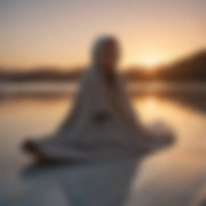 Billabong hooded towel hanging on a surfboard at sunset