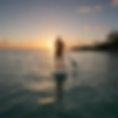 Stand-up paddleboarder enjoying the calm seas at sunset in Providenciales