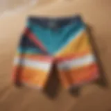 Vibrant surf board shorts displayed on a sandy beach