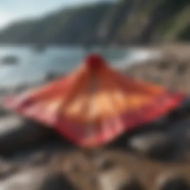 A vibrant changing poncho laid out on a rocky shoreline