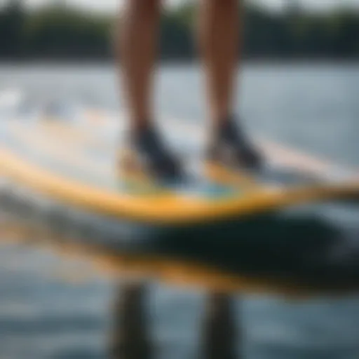 A close-up view of a hydrofoil mounted on a stand-up paddleboard, showcasing the intricate design and engineering.