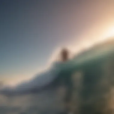 Aerial view of a surfer catching a wave at sunset