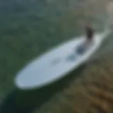 Aerial view of a foil board slicing through crystal clear waters