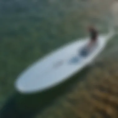 Aerial view of a foil board slicing through crystal clear waters