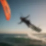 Graceful kitesurfer performing aerial trick over ocean