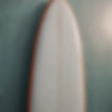 Close-up of a surfboard displaying unique wall art.