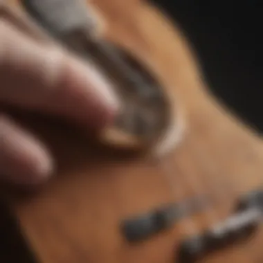 Close-up of ukulele strings being tuned by ear