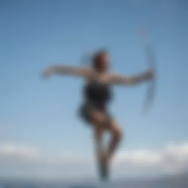 Kite surfer performing tricks under the clear blue skies of Maui