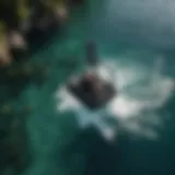 Aerial view of a person riding a Lift eFoil over crystal clear waters