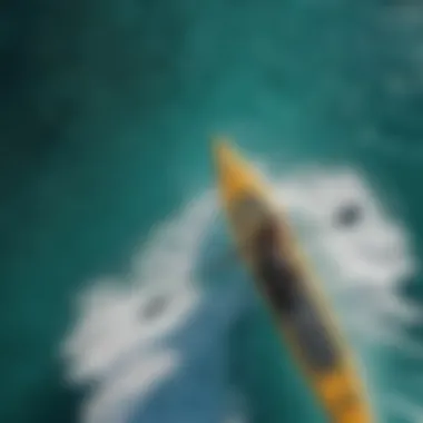 Overhead view of stand-up paddle surfer navigating turquoise ocean