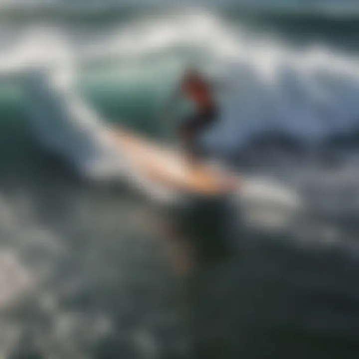 Elevated view of motor-powered surfboard cutting through waves