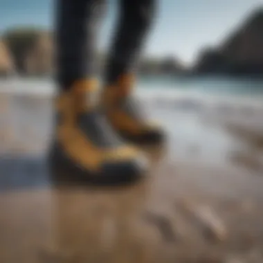 A pair of Ripcurl booties on a rocky beach before watersport activity