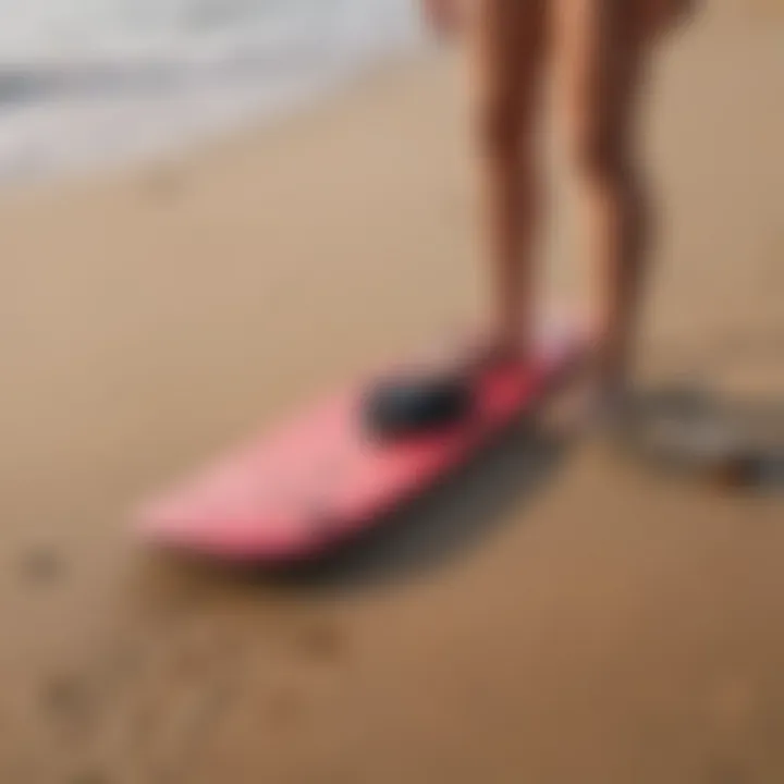 Essential gear for skimmer boarding laid out on the sand