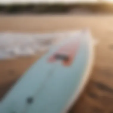 Soft top surfboard on sandy beach