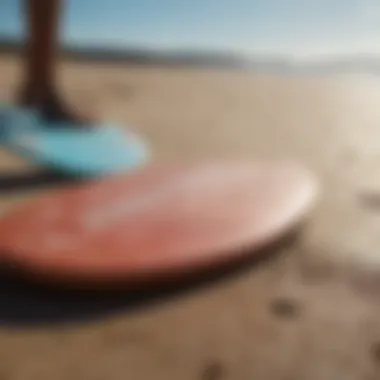 A close-up of essential skimboarding gear laid out on the beach.