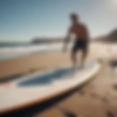 Surfer using change mat to maintain surfboard on shoreline