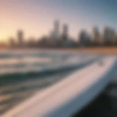 Surfboard with city skyline in the background at St Kilda Beach