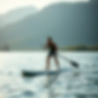 A person practicing paddle boarding skills on the water