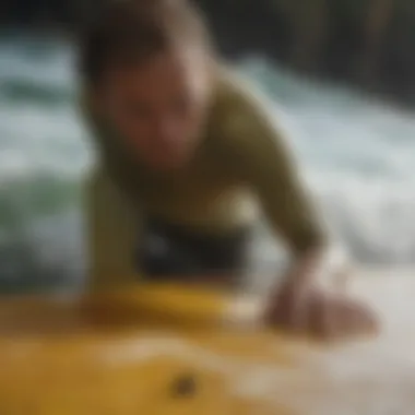 Application of surfing wax on a surfboard