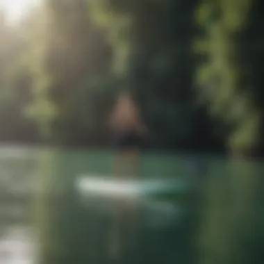 Stand-up paddleboarder gliding on peaceful waters surrounded by lush greenery