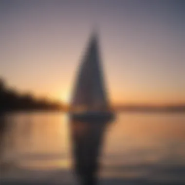 Sunset silhouette of a sailboat gliding through the calm waters of a lake