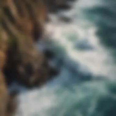 An aerial view of crashing waves against rocky cliffs, illustrating the dynamic power of the ocean.