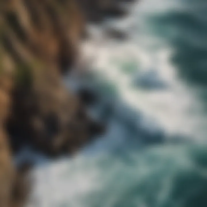 An aerial view of crashing waves against rocky cliffs, illustrating the dynamic power of the ocean.