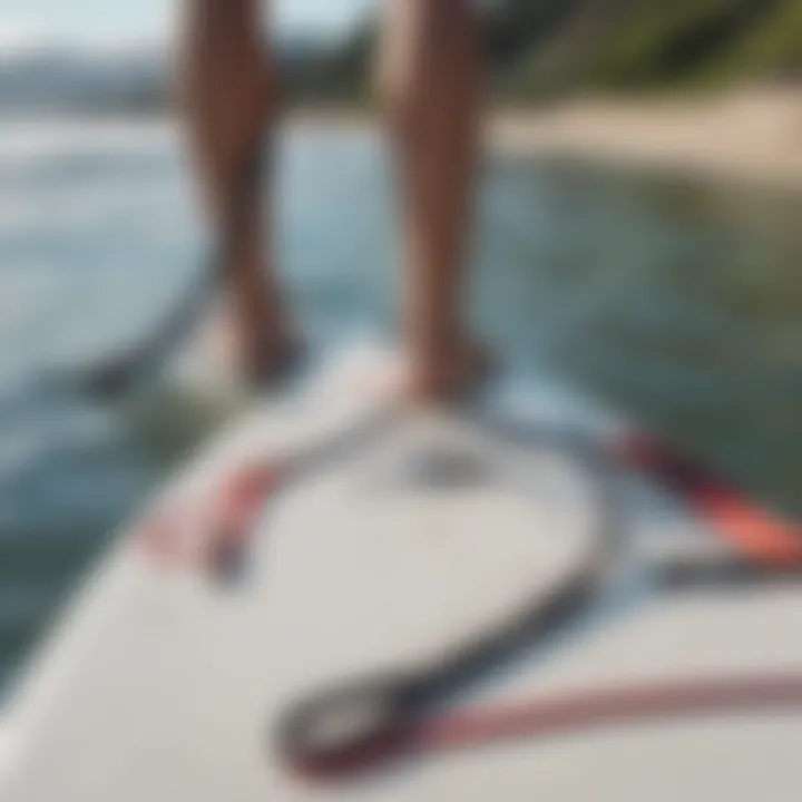 White surf leash attached to a paddleboard on calm waters